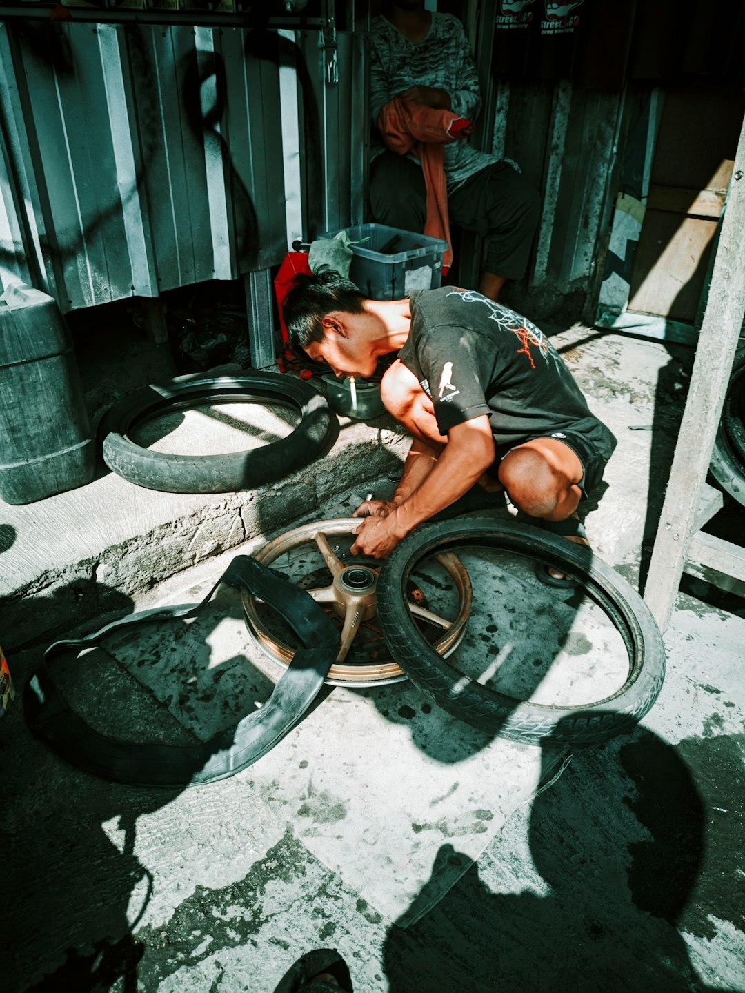young man repairing bicycle