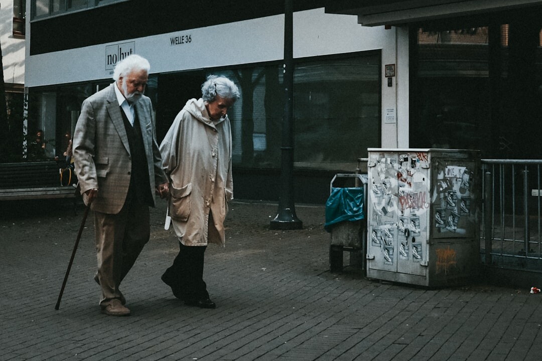 elderly couple holding hands