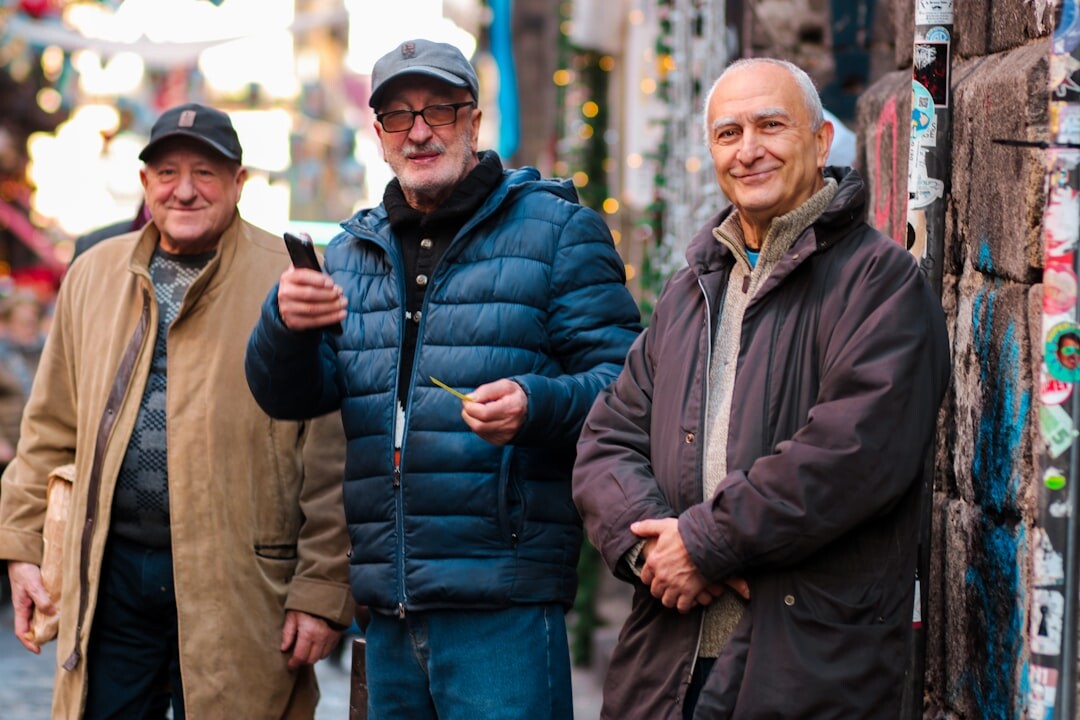 group of older men sharing photos