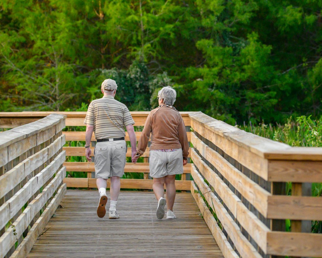 elderly couple holding hands